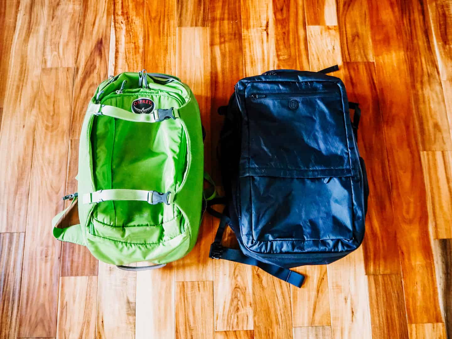 1 green and 1 black backpack side by side